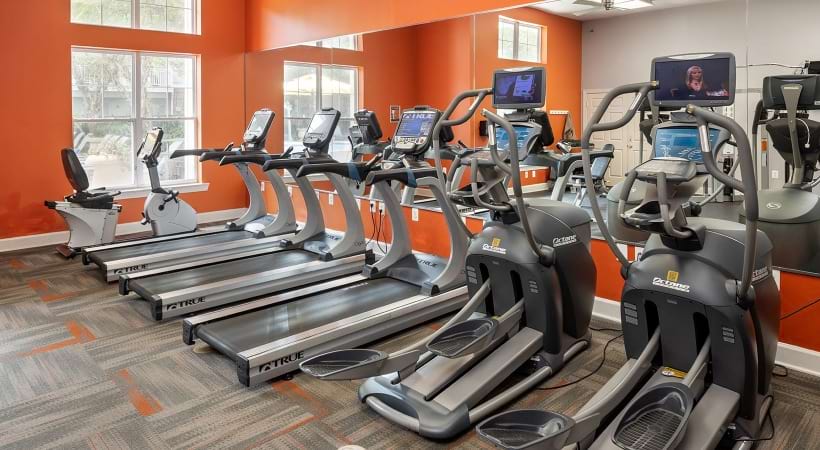 fitness center with large open spaces allowing room for workouts and for using equipment